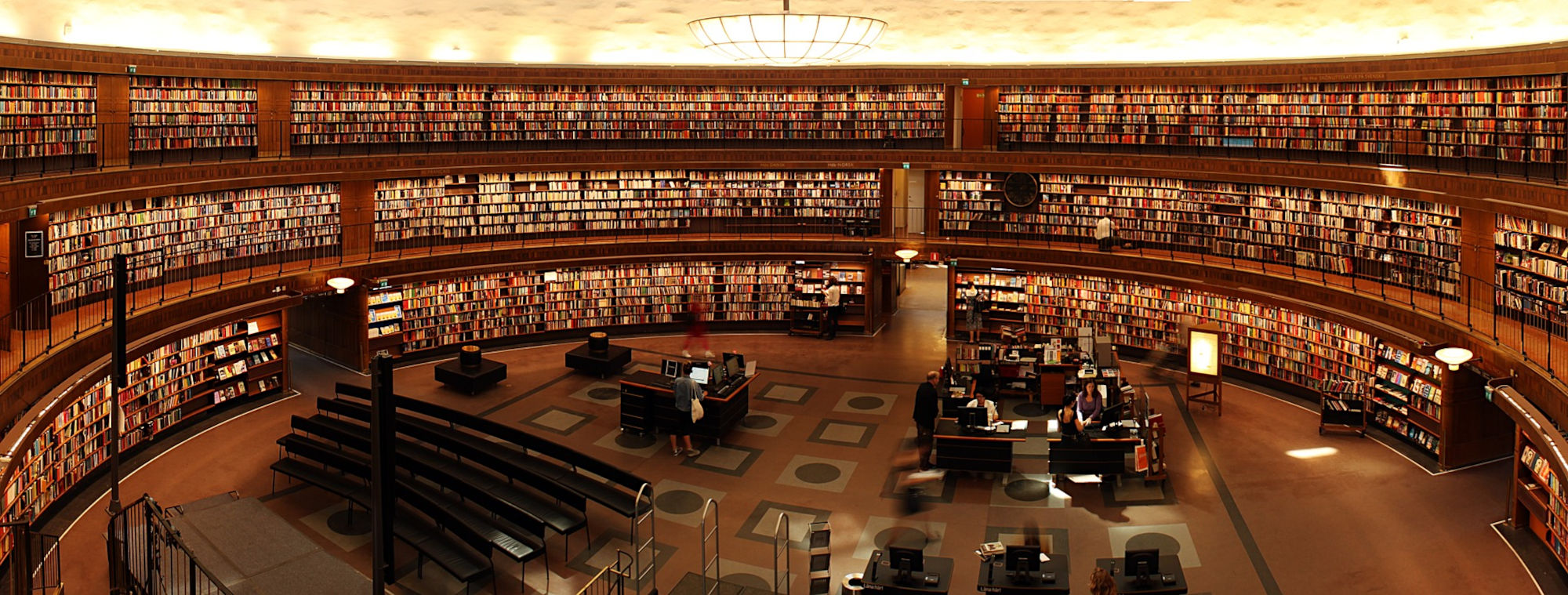 A large circular library full of book shelves and books